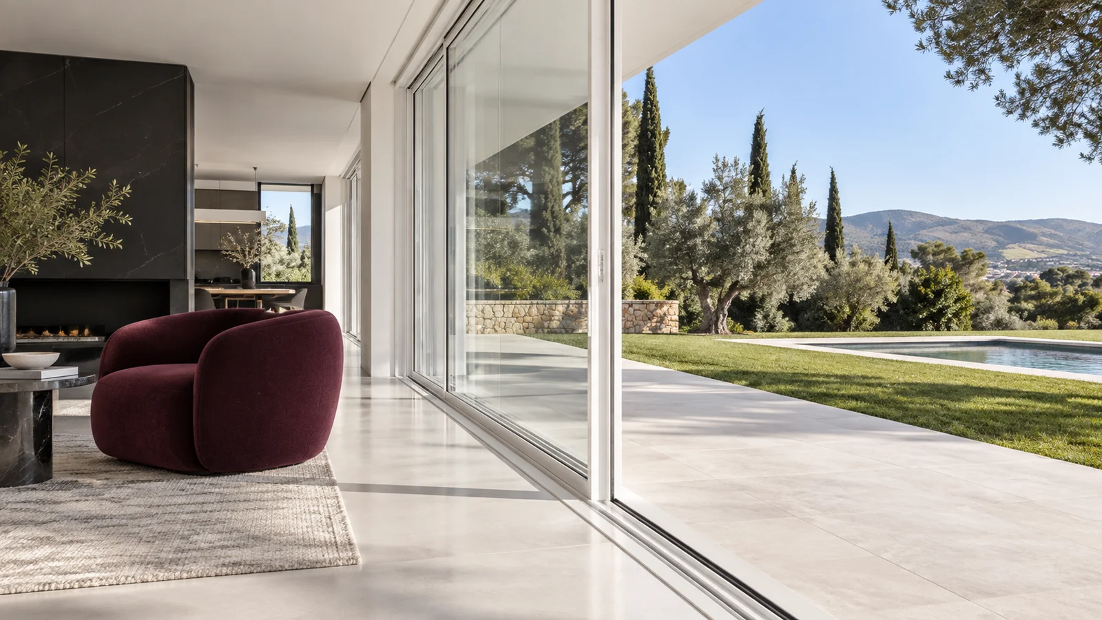 Ambient conceptual amb finestrals blancs oberts a un jardí i una butaca granat